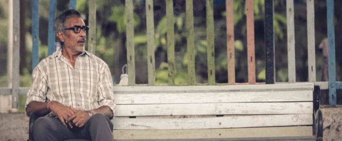 Prakash Jha on a park bench — still from Justaju, as published by BroadwayWorld India