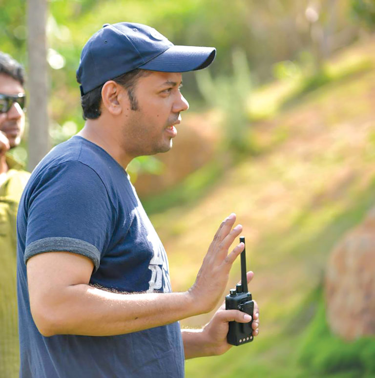 Mudassir Mashalkar directing on set, radio in hand